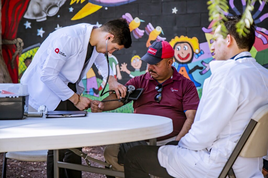 A medical personnel checking a patient's blood pressure